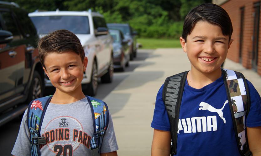 Two students smile